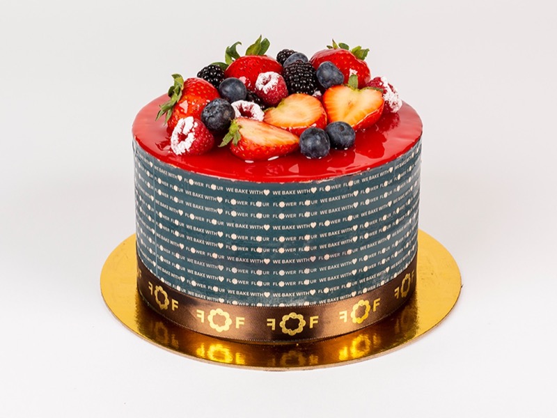 Guava cake with a pink guava top and fresh berries