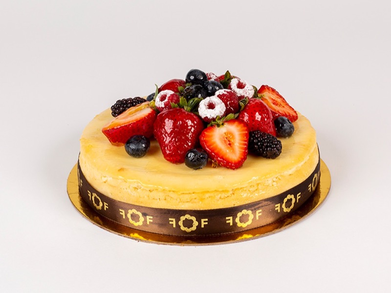 New York cheesecake topped with strawberries, blackberries, and blueberries