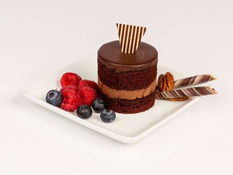 Individual chocolate dessert with a chocolate fan and fresh berries