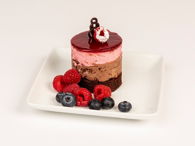 Individual raspberry dessert with chocolate and fresh berries