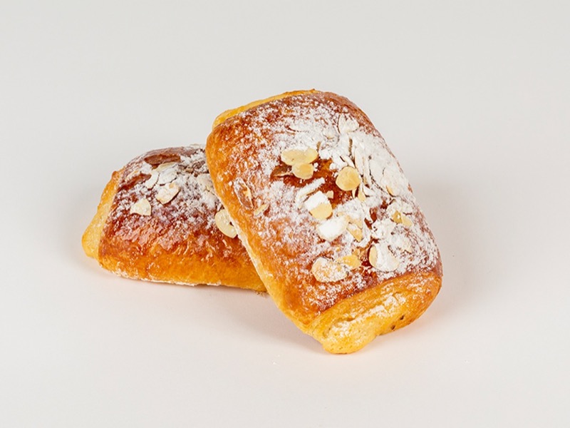 Almond croissants dusted with powdered sugar and sliced almonds
