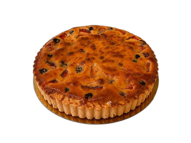 Whole mixed berry pie with berry filling, whipped cream, and a fluted crust