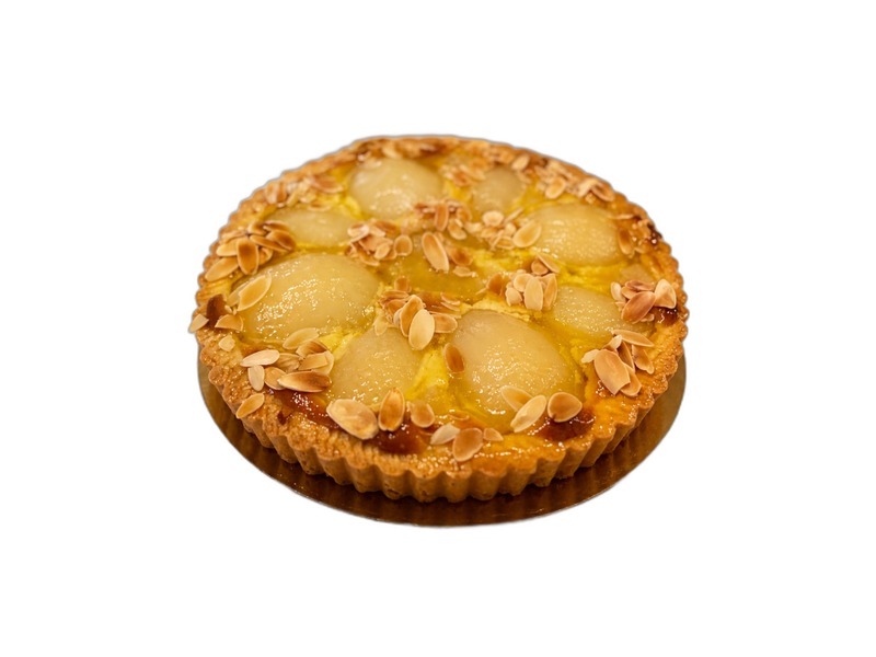 Whole pear tart with glazed pear halves, toasted almonds, and a fluted crust on a gold board