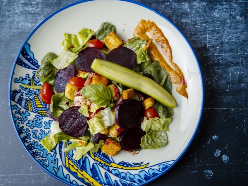 A beet salad with mixed greens