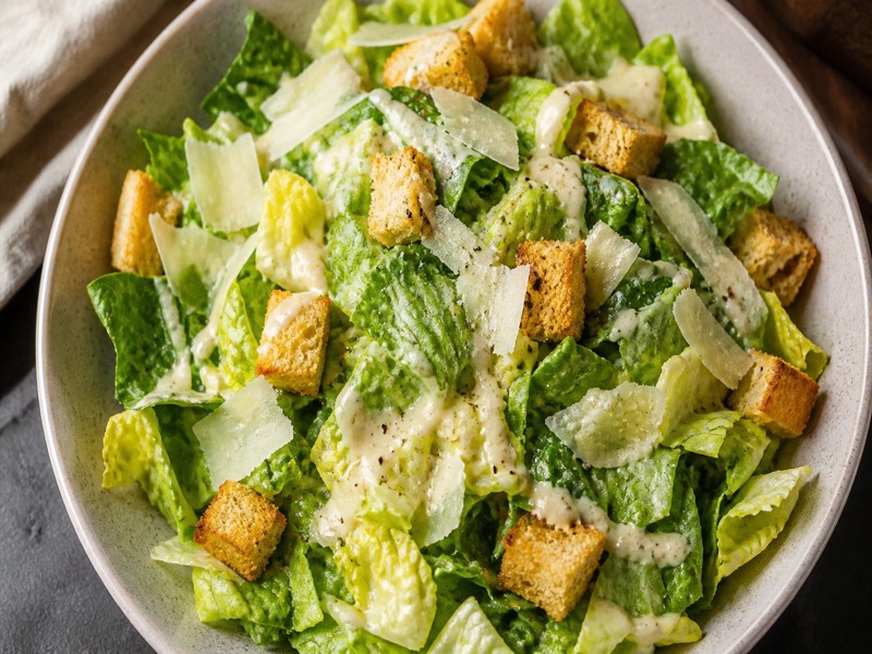 Caesar salad with romaine, croutons, and shaved parmesan