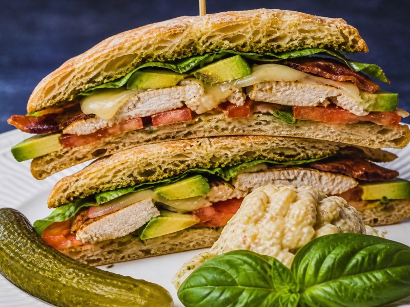 California chicken sandwich with avocado, bacon, and Swiss on ciabatta