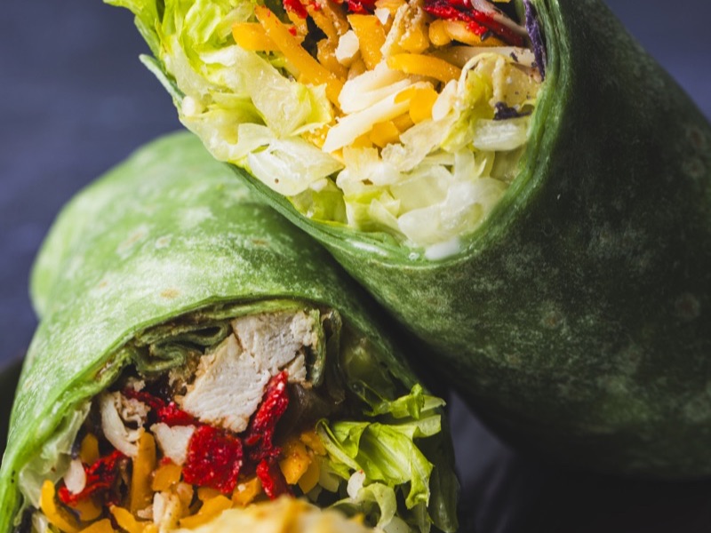 A BBQ chicken wrap cut in half