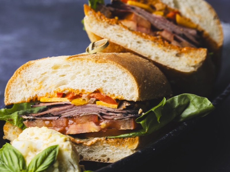 A pastrami sandwich cut and stacked